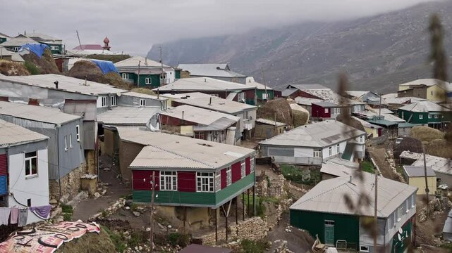 Steep stone dwellings terracing rugged mountainside in xinaliq, traditional azerbaijani village nestled within caucasus mountain landscape