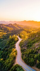 Curving road along a mountain ridge at golden hour with panoramic valley view