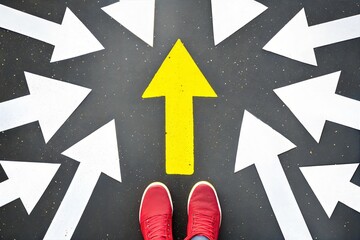 Fototapeta premium Person standing at a crossroad with multiple arrows, choosing the right path for life decisions and growth