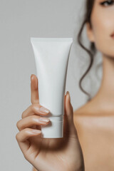 Beautiful beauty female woman's model hand holding white empty blank mockup skincare cream tube template, cosmetics commercial ad on white background.