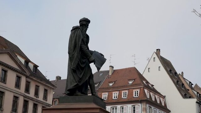 Statue of Johannes Gutenberg on Gutenberg square against overcast sky, made by artist David d'Angers
