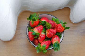 Fresh Organic Ripe Strawberries In A Porcelain Bowl over wooden background