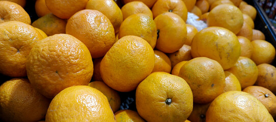 Close up of fresh oranges fruit on grocery store