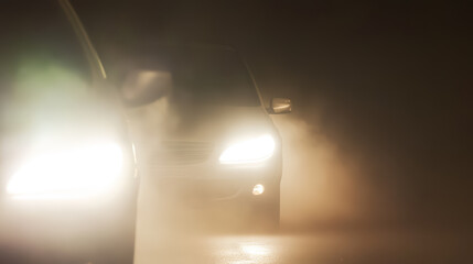 Headlights of a car in foggy weather