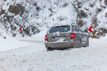 Car on the snowy mountain road during severe conditions