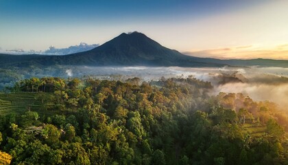 Obraz premium Generated image Drone shot of Mount Agung rising majestically above misty forests at sunrise