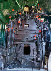 The firebox and steam control systems and gauges  foran old steam  train locomotive engine © Patrick Rolands