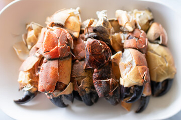 Steamed stone crab claws served with a spicy seafood dipping sauce are popular dishes in local street food in Thailand.