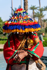 Marrakesh, Morocco, Africa. Portrait closeup of traditional water seller (Guerrab) with colorful...