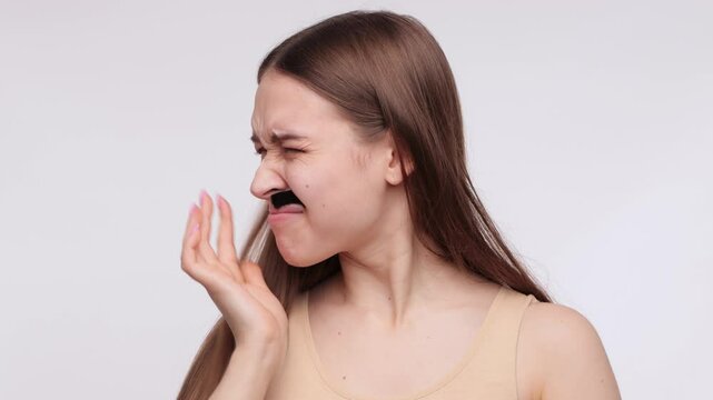 A girl removes her moustache with wax strips. A procedure for removing hair on a woman's body.A girl removes her moustache with wax strips. A procedure for removing hair on a woman's body.