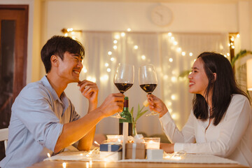 dining, party, romance, couple, affection, anniversary, valentine, celebration, luxury, affectionate. A man and woman are sitting with wine glasses in their hands. They are smiling and enjoying.