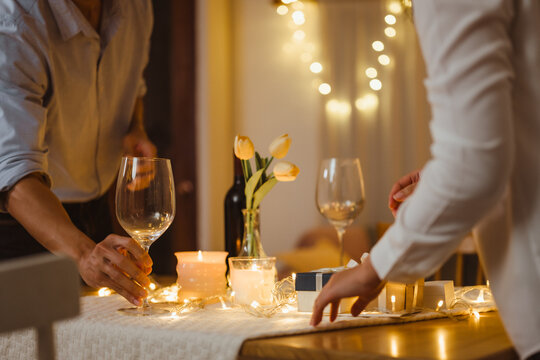 valentine, celebrate, couple, romantic, anniversary, romance, affection, affectionate, diner, loving. A man and woman are setting up a table for dinner. as the couple prepares for a special together. - Powered by Adobe