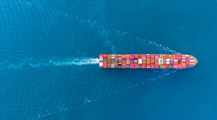 Top view Cargo Container ship with contrail in the ocean ship carrying container and running for import export concept technology freight shipping by ship. - obrazy, fototapety, plakaty