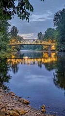 Obraz premium Tranquil Evening View of Bridge Over Calm River at Sunset