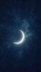 Fototapeta premium Glowing crescent moon emerging through misty night clouds