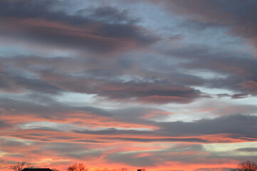 Picturesque sunset with aurora-like clouds in shades of pink and blue