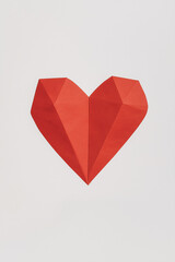 Geometric Heart: A bold, graphic heart in a vibrant red hue crafted from folded paper, creating a minimalist and modern design. It is a symbol of love, affection, and passion.