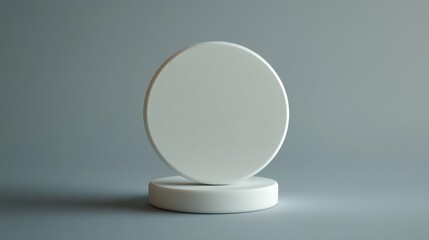 Round white objects placed on a gray background creating a minimalist aesthetic for design purposes
