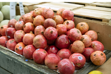 ripe pomegranates in great variety on the farm store counter.
