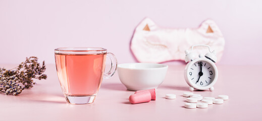 Concept insomnia accessories and sleep medications on pink web banner
