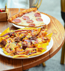 Nachos with meat and cheese on the table in a restaurant