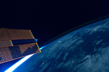 A space satellite above the Earth's surface. Elements of this image furnished by NASA