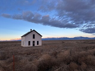 Abandoned House at Sunset in Vast Open Landscape