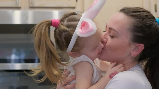 Loving mother with daughter in bunny ears on Easter holiday. Close-up
