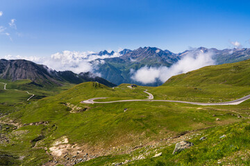 Beautiful view of winding Hochalpenstrasse road in Austria. serpentine road passes through majestic mountain ranges partially shrouded in clouds.Grossglockner high alpine road