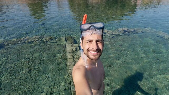 Selfie view of man diver on an ancient underwater city of epidaurus in Greece