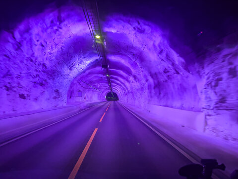 Purple illuminated road inside the laerdal tunnel in norway