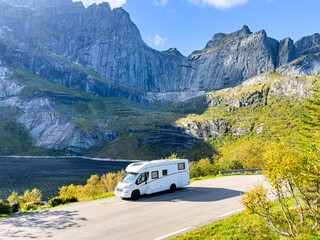 Scenic drive through norway's majestic mountains in a white camper van offers a breathtaking view...