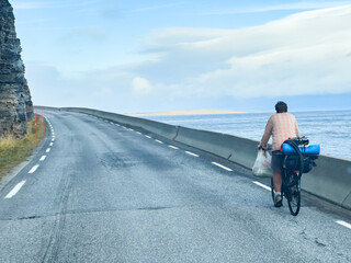Capturing a cyclist's scenic ride along the atlantic ocean road in norway from a camper van's viewpoint
