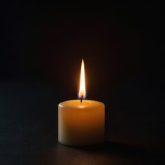A glowing candle flame pierces the black darkness