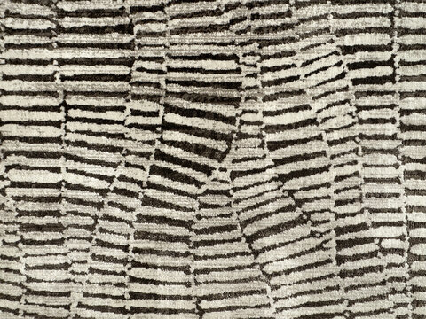 Close up of carpet rug fabric in snake scale pattern, or in random horizontal stripes pattern. In black and white color, monochrome concept. Seamless background texture.