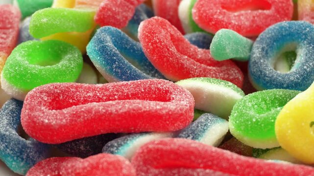 Rotating sugar jelly sweet marmalade candies. Tasty colorful chewy gummy sweets treat