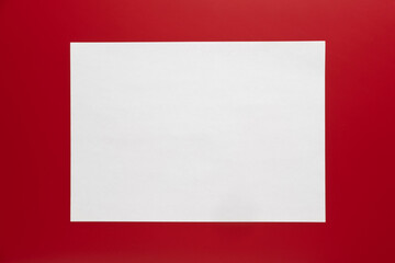 Blank white sheet on bright red background for art or design projects and presentations