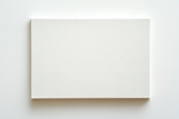 Blank white canvas on white background, studio shot, art mockup