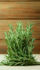 Fototapeta premium Fresh rosemary sprigs on wooden background, culinary herb, cooking ingredient, food photography, recipe website