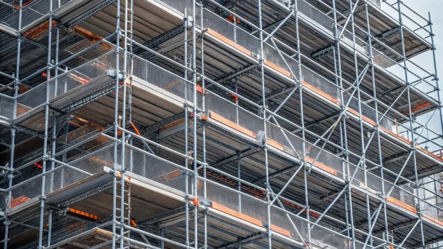 A closeup of modern scaffolding featuring galvanized steel and safety features showcasing the stark contrast to earlier construction ods while emphasizing the organization and
