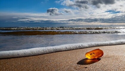 Obraz premium Generated image A close-up of Baltic Sea amber washed up on a sandy beach, with waves gently rolling