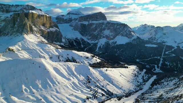 The Stazione di Arrivo Funivia Campitello and the Forcella del Sassolungo stand out in the breathtaking Val di Fassa ski resort in winter time captured by drone