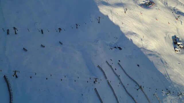 The Stazione di Arrivo Funivia Campitello and the Forcella del Sassolungo stand out in the breathtaking Val di Fassa ski resort in winter time captured by drone