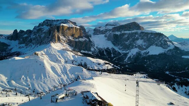 The Stazione di Arrivo Funivia Campitello and the Forcella del Sassolungo stand out in the breathtaking Val di Fassa ski resort in winter time captured by drone