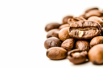 Naklejka premium Close-Up of Freshly Roasted Coffee Beans on a White Background