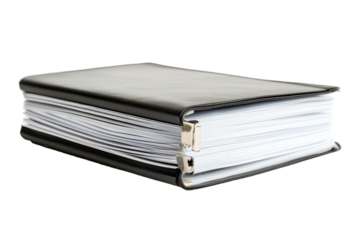 Black binder filled with numerous documents resting on a flat surface in an office setting