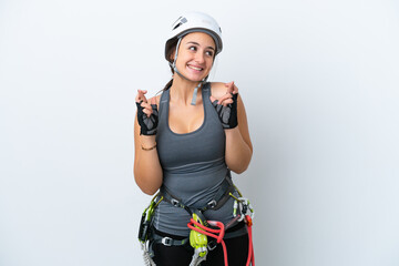 Young Ukrainian rock climber woman isolated on white background with fingers crossing