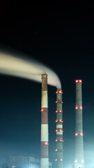 Night over the industrial city.Factory chimneys smoke.Environmental problem of environmental and atmospheric pollution.Climate change,environmental disaster.The sky is smoky with toxic substances