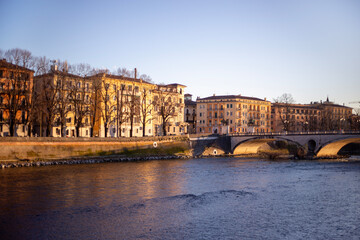 Fototapeta premium Italian city River Adige with bridge and buildings