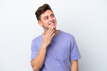 Young handsome Brazilian man isolated on white background looking up while smiling